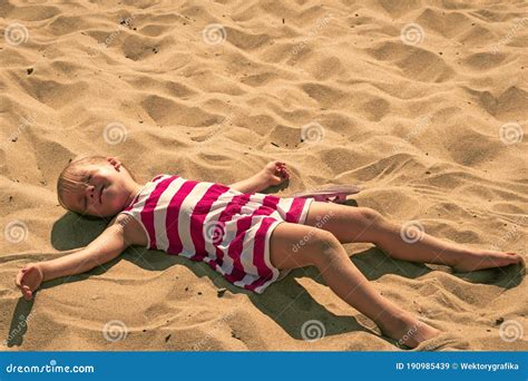 Baby Girl Lying On Sand Adorable Kid Sunbathing At Summertime Young