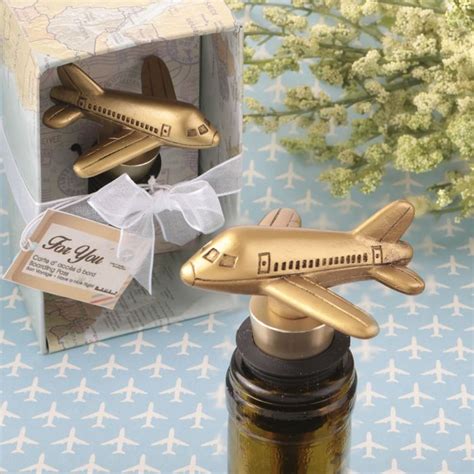 a gold airplane bottle stopper sitting next to a box with a map on it