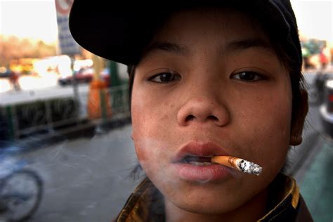 china public smoking ban introduced in beijing capital of a country of smokers [photo report