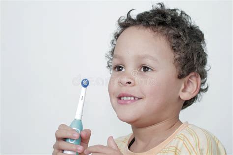 Boy Brushing His Teeth With An Electric Tooth Brush Stock Photo Stock