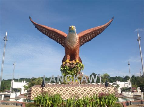 The rooster crows more frantically as rolling pillars of dark clouds cascade across the heavens to the east. Eagle Square in Langkawi, Malaysia. | Langkawi, Animals, Birds