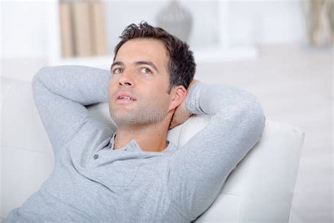 Man Relaxing On Sofa At Home Stock Photo Image Of Person Confident
