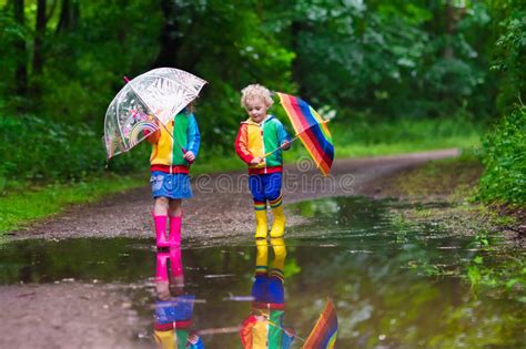 A cloud appears in teletubbyland. Kids playing in the rain stock image. Image of preschooler ...