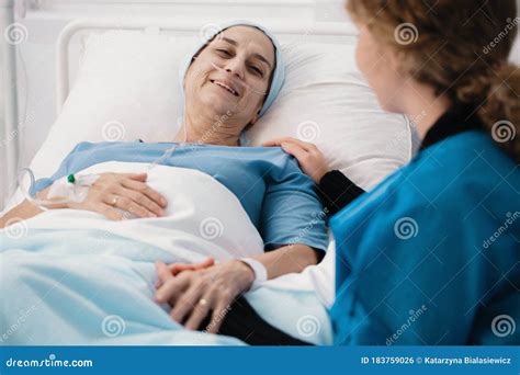 Caregiver And Positive Woman With Cancer In The Hospice Stock Photo