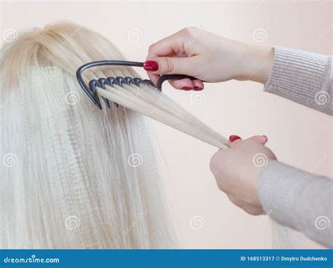 Hairdresser Is Combing Her Long Hair Of Beautiful Blonde Woman In The