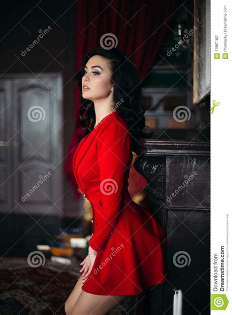 brunette woman wearing in red seductive leaning on wall stock image image of glamour
