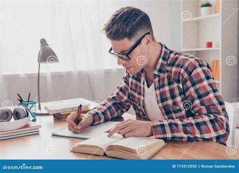 Portrait Of Hardworking Student With Book Preparing For Test In