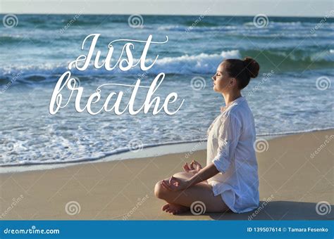 Young Woman Making Meditation On The Beach Near The Sea Stock Photo