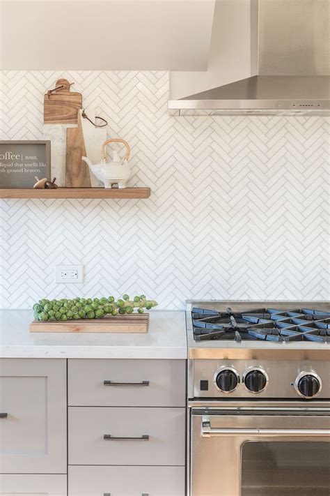 Contemporary kitchen with white marble backsplash tiles. Marble Herringbone Backsplash // Kitchen floating shelves ...