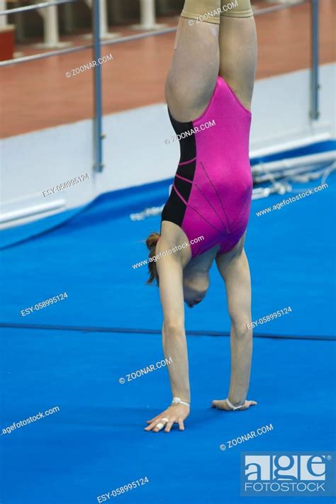 Young Female Gymnast Doing A Handstand At The Stadium Close Up Stock