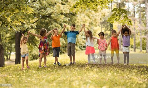 Large Group Of Small Children Holding Hands In Nature High Res Stock
