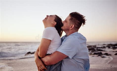 Sunset Love And Young Couple On The Beach Bonding Laughing And