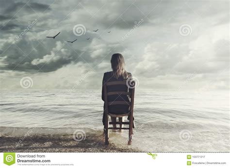 Surreal Woman Looks At The Infinite Sitting On A Chair Inside The Sea Royalty Free Stock