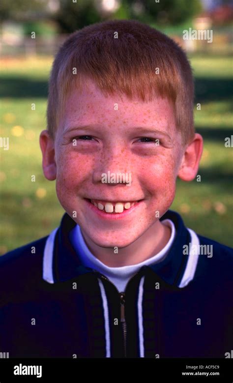Portrait Of 10 Year Old Redhead Boy With Freckles Smiling Stock Photo