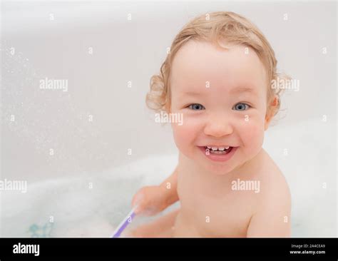 Funny Happy Baby With Curly Hair Taking Bath And Brushing Her Teeth A
