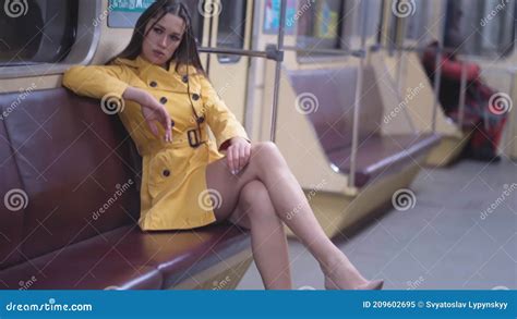 Woman In Yellow Spring Coat Riding Empty Metro Train Showing Her
