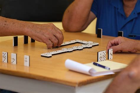 Group Of Senior People In Retirement Home Playing Domino Stock Photo