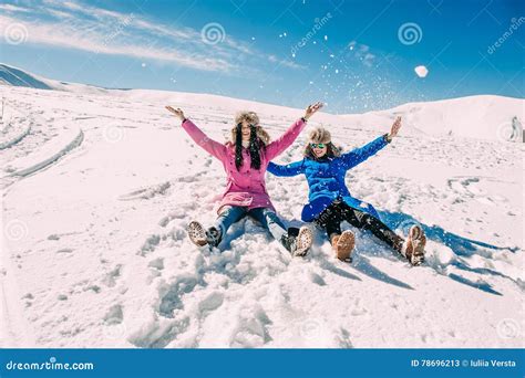 Winter Two Girls Having Fun In The Snow In The Mountains Stock Image