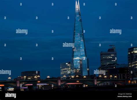 The Shard In Central London At Dusk Reflecting In The Thames River