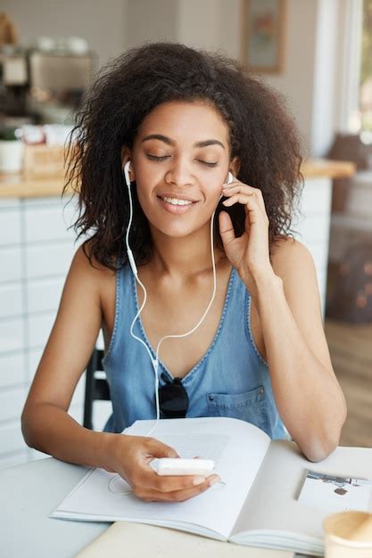 Free Photo Portrait Of Happy Beautiful African Woman Listening To Music In Headphones Smiling