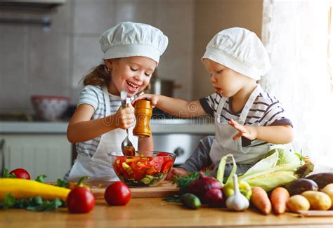 Healthy Eating Happy Children Prepares Vegetable Salad In Kitc Stock