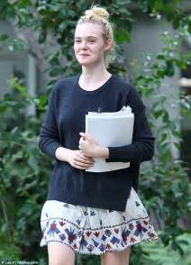 Elle Fanning Carries A Stack Of Scripts While Parading Her Pale Pins In