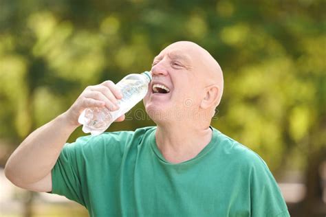 Elderly Man Drinking Water Outdoors Stock Image Image Of Retiree