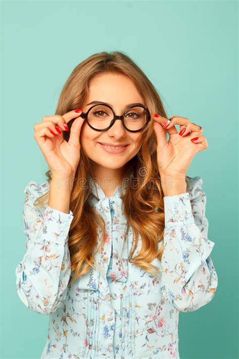 Pretty Smiley Girl Wearing Glasses Over Blue Background Stock Image