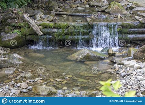 Mountain River In The Summer With Small Waterfalls