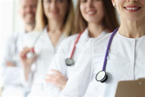 Team Of Doctor In White Coats And Stethoscopes Stand Together Stock