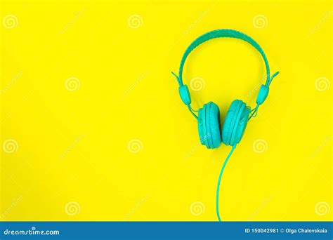 Turquoise Or Blue Headphones Or A Computer Headset On A Yellow