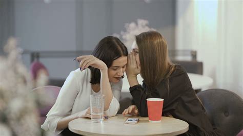 Two Friends Share Secrets In Cozy Cafe Stock Footage Sbv 318425368 Storyblocks
