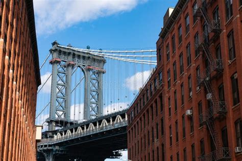 The Manhattan Bridge Between Old Red Brick Buildings In Dumbo Brooklyn