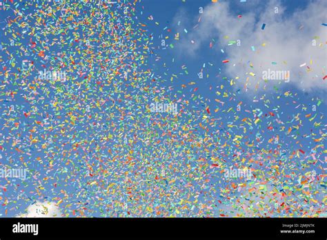 A Colorful Confetti On The Air With Blue Sky Background Stock Photo Alamy