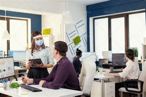 Businesses don't like you to do it because it lets others see. Coworkers With Visors Discussing - Stock Photos | Motion Array
