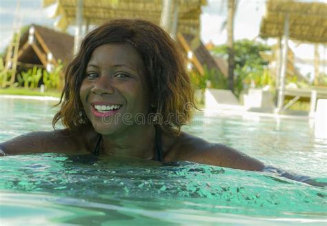 happy and beautiful black african american woman in bikini having fun at tropical beach resort