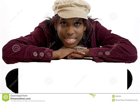 Young Black Woman Leaning Over A Blank Sign For Copy Space Stock Photo