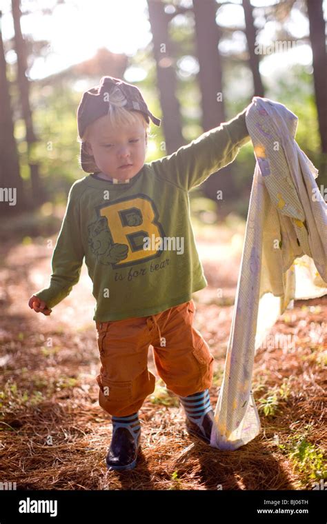 Young Boy Carrying A Blanket In The Woods Stock Photo Alamy