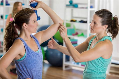 Personal Trainer Instructs Client Fitness And Wellness News
