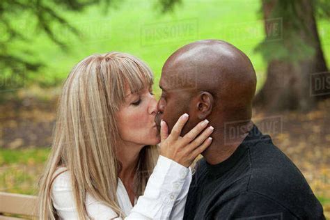 Interracial Couple Kissing In A Park Edmonton Alberta Canada Stock