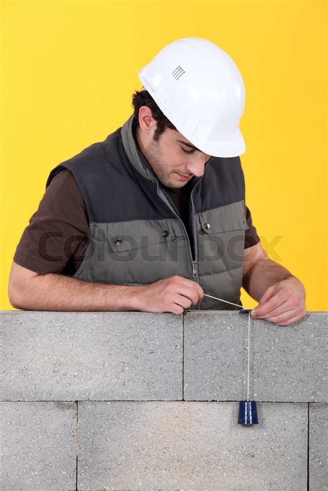 A Mason Using A Plumb Bob To Check His Wall Stock Image Colourbox