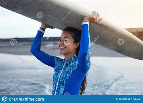 Surfer Girl Surfing Woman Holding White Surfboard On Head Smiling Brunette In Blue Wetsuit