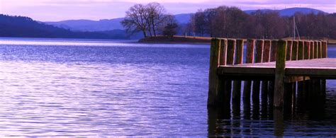 1600x1200 Resolution Brown Wooden Deck In Body Of Water At Sunrise