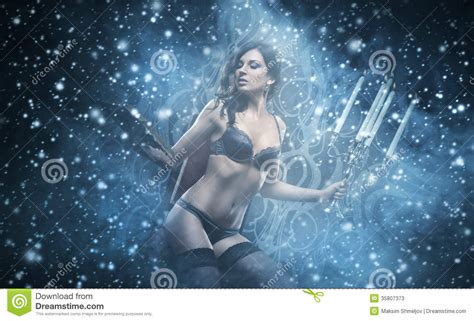 Fashion Shoot Of A Woman In Lingerie Holding Candles Stock Image