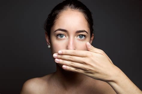Beautiful Young Woman Covering Her Mouth With Hand Isolated Photo
