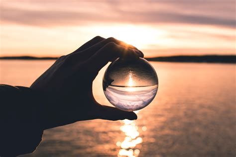 Free Photo Photo Displays Person Holding Ball With Reflection Of