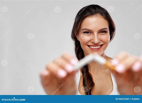 Beautiful Happy Female With Broken Cigarette Quitting To Smoke Stock