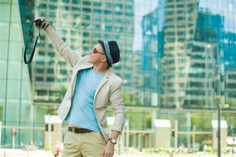 Man Makes Selfie In The Big City Against The Background Of Skyscrapers