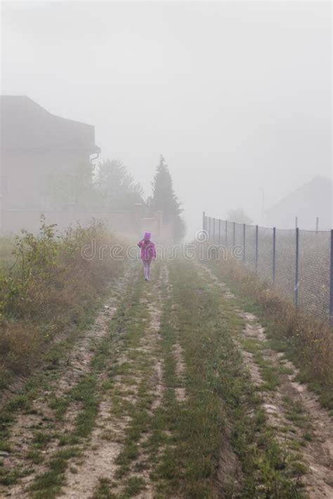 Mountain From View With Small Village And Flow Fog Little Girl In Red