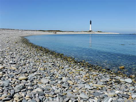 Gravel Beach With Lighthouse In The Background Photograph By Stefan Rotter